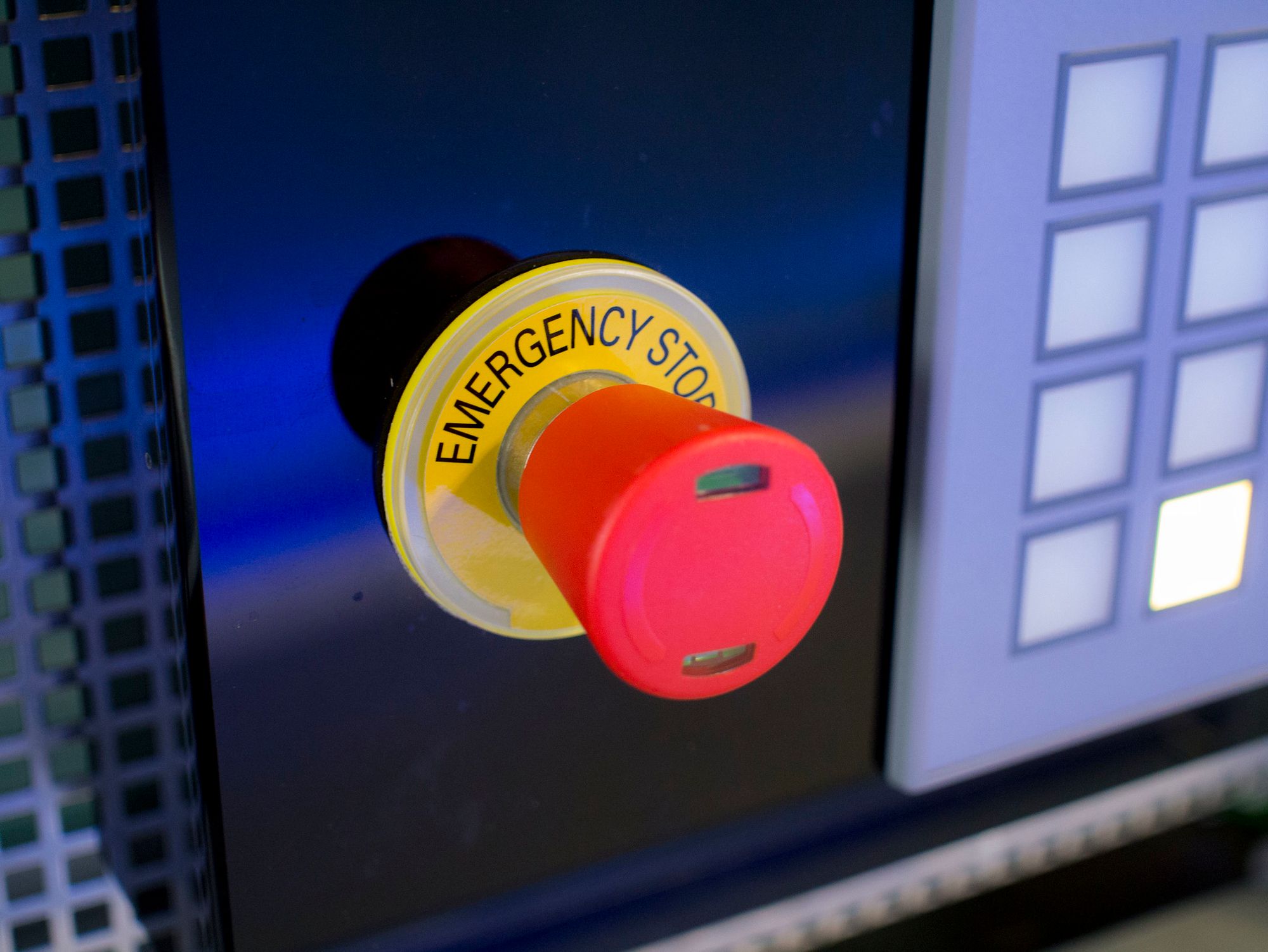 A big red button with the words "emergency stop" visible around the base